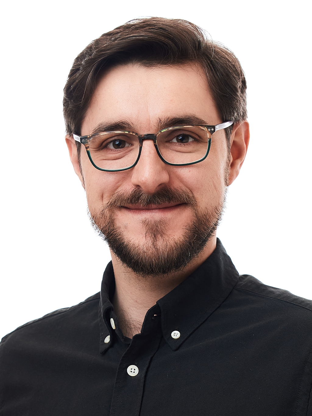 Man with glasses, smiling towards the camera