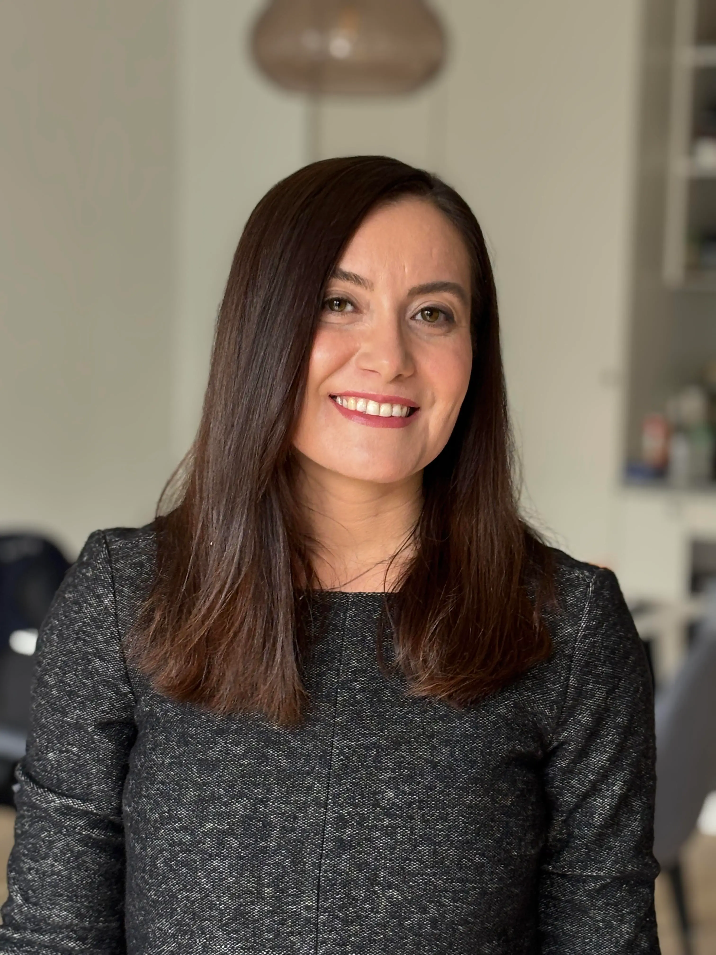 Neziha Akalin, smiling and looking directly into the camera