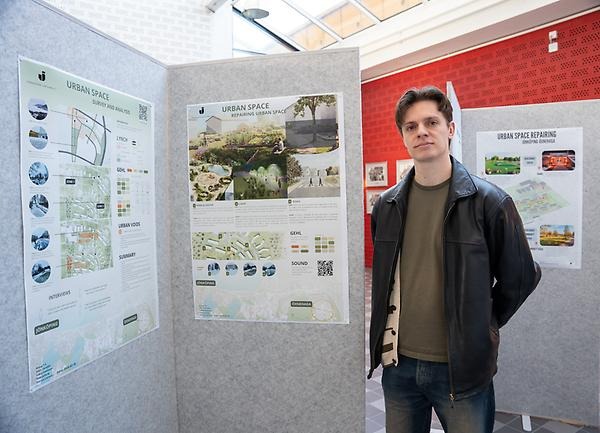 Lukas Svensson standing infront of the sketches