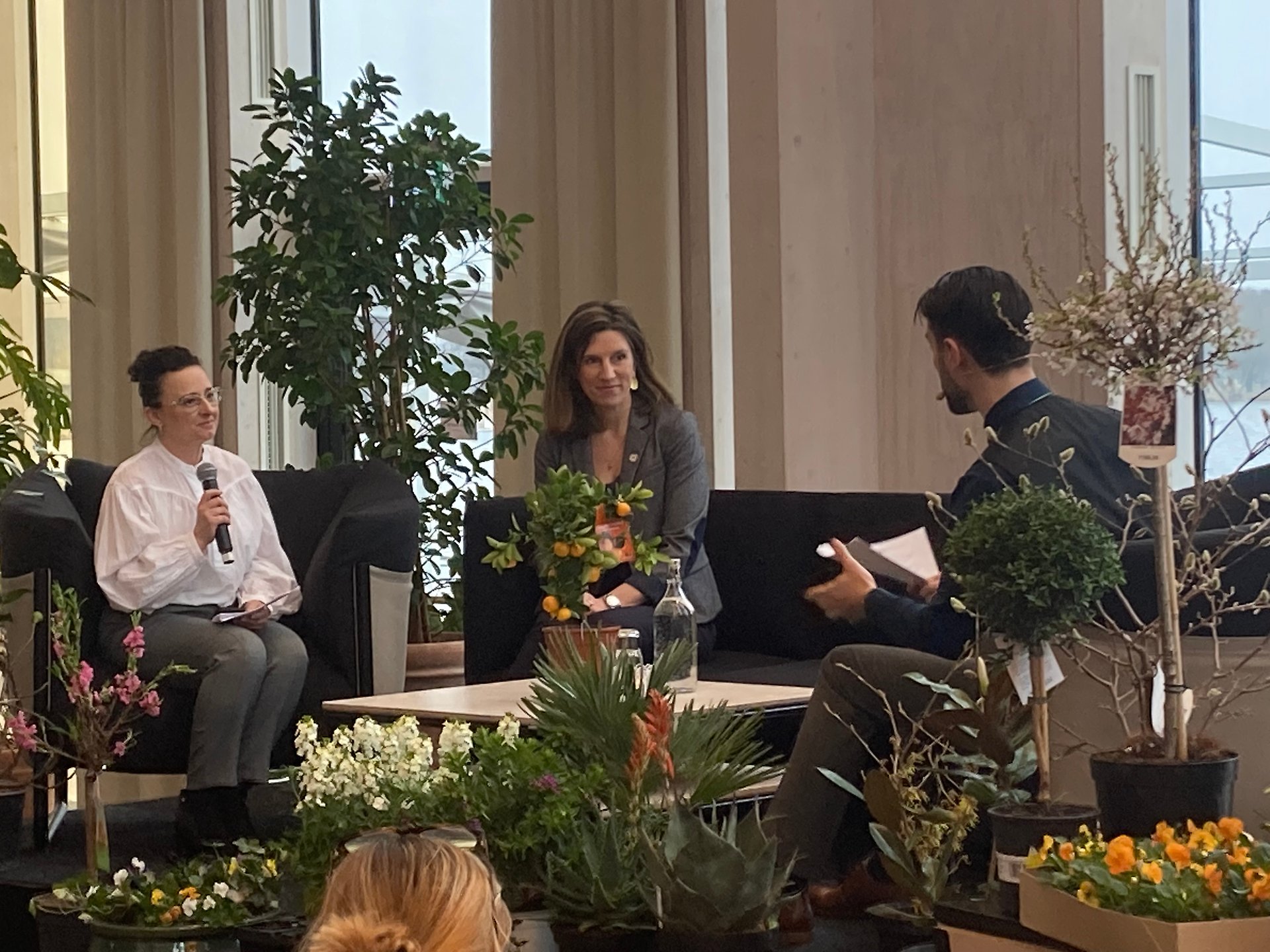 Interviewer and two guests on stage