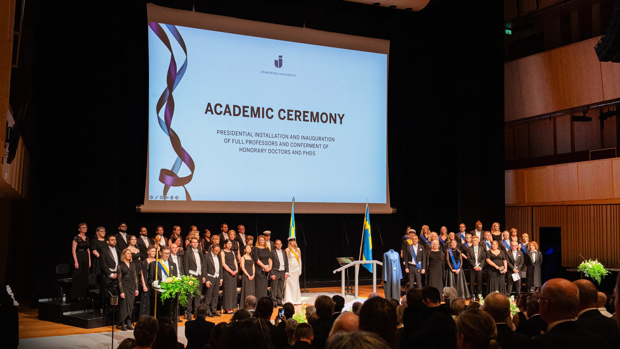 A group of people standing on top of a stage.