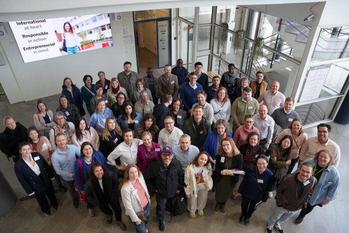 Group of 50 conference participants looking to the camera