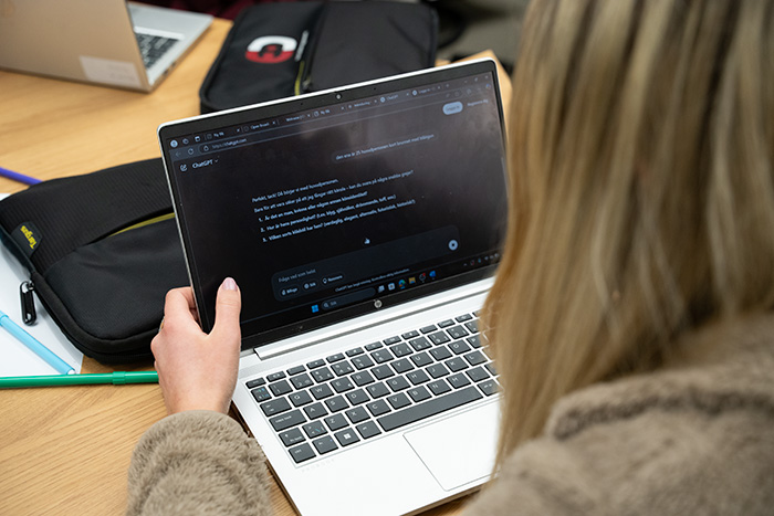 Student seen from behind at their computer