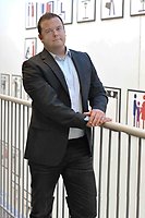 Man wearing suit looking towards camera