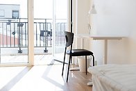 Student housing interior, a room with a bed and a desk