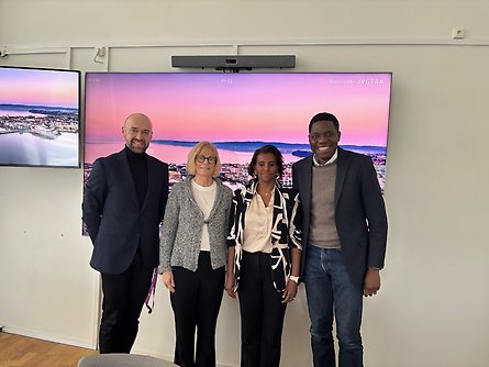 Fyery Adhena Abreha standing with faculty members